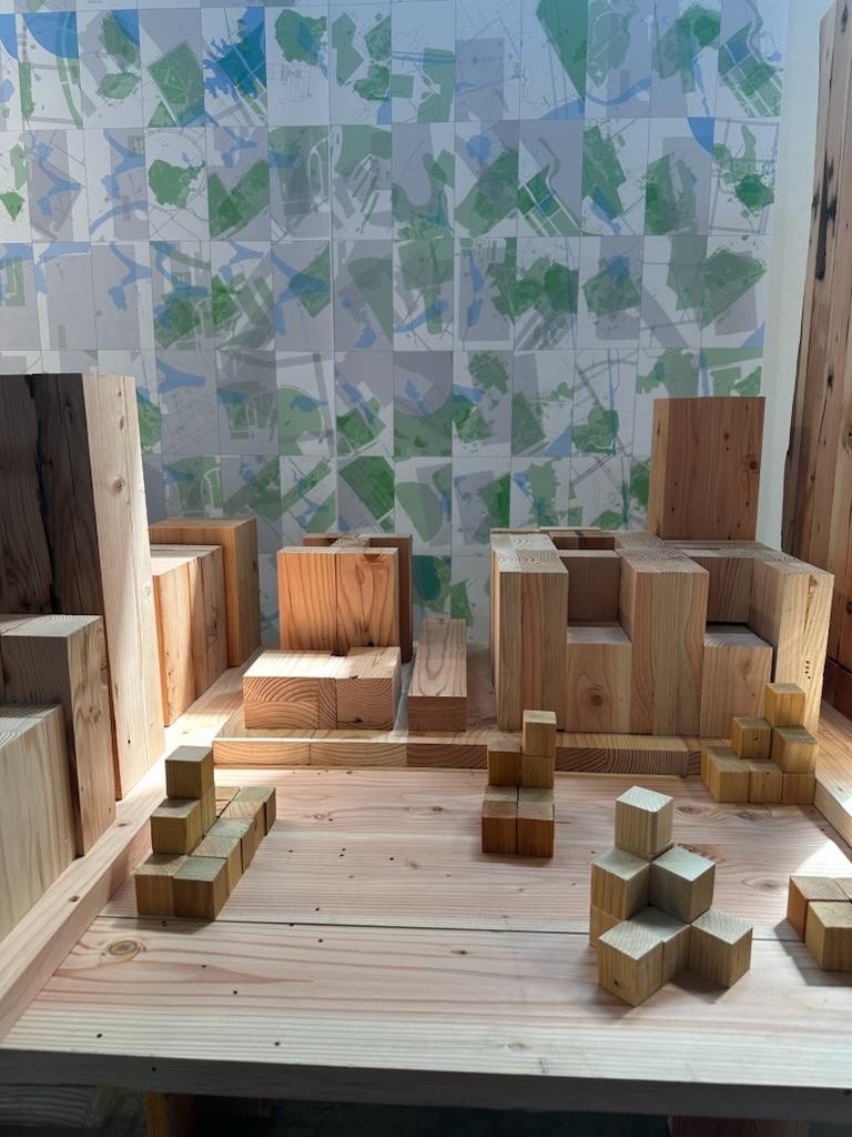 Timber site model against the painted map wall
